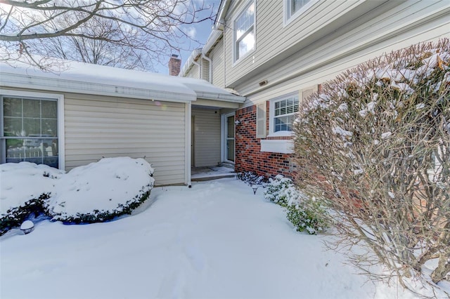 view of snow covered property entrance