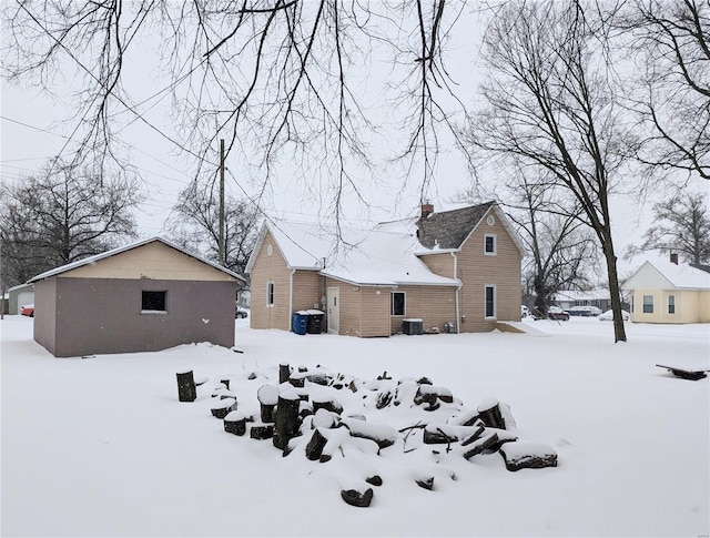 view of snow covered rear of property