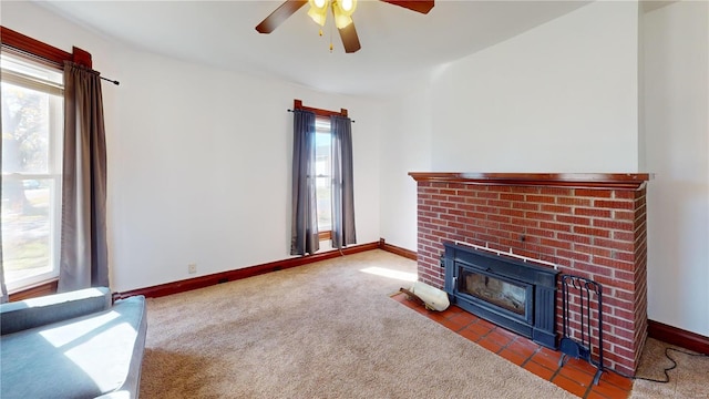 carpeted living room featuring a brick fireplace and ceiling fan