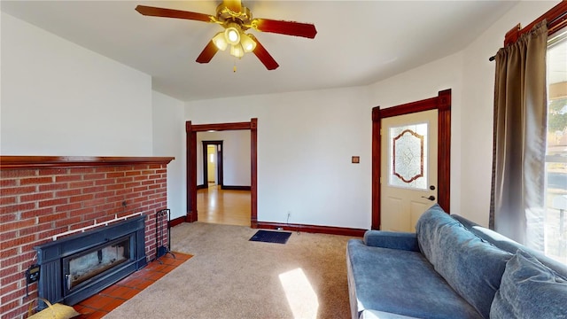 living room with ceiling fan, carpet floors, and a fireplace