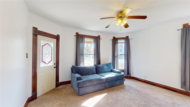 living area featuring ceiling fan and light colored carpet