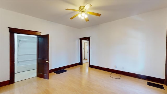 unfurnished room with ceiling fan and light wood-type flooring