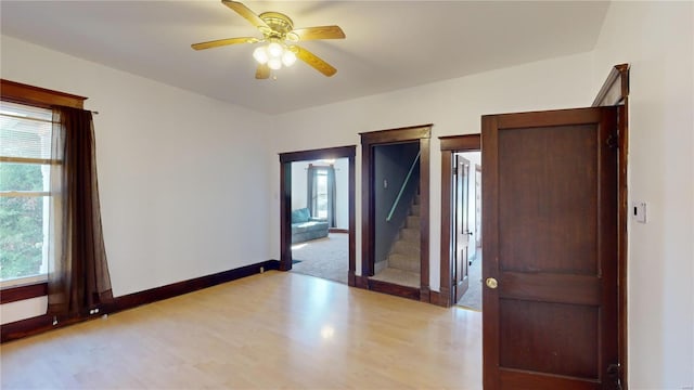 spare room with light hardwood / wood-style flooring and ceiling fan