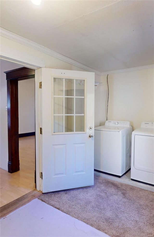 laundry room with light carpet, ornamental molding, and independent washer and dryer