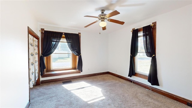 carpeted empty room featuring ceiling fan