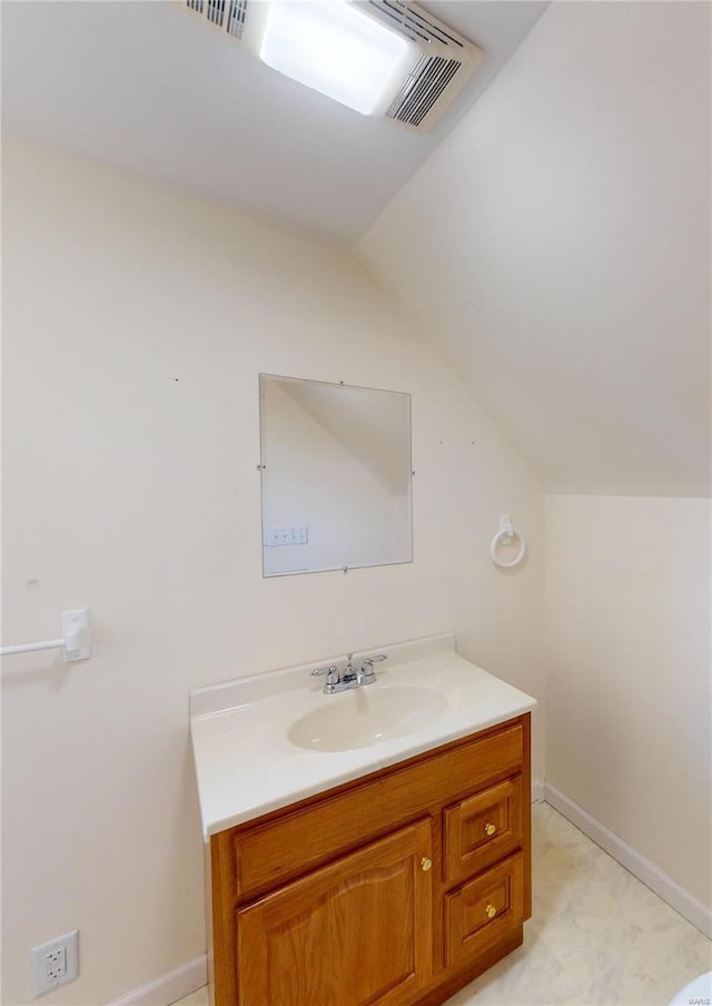 bathroom with vanity and lofted ceiling