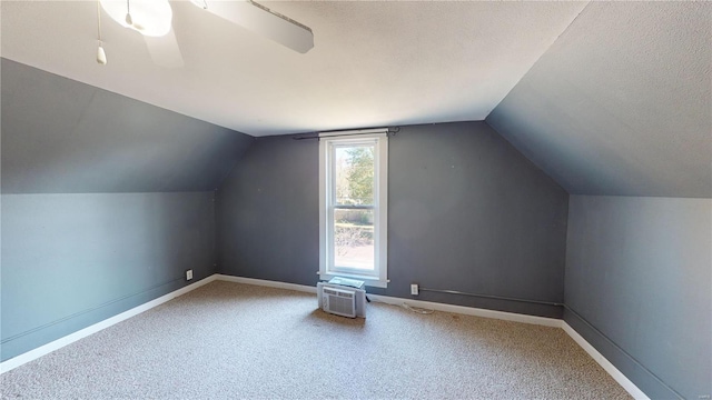 additional living space with carpet flooring, a textured ceiling, and vaulted ceiling