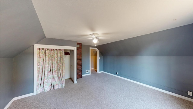 additional living space featuring ceiling fan, carpet floors, and vaulted ceiling