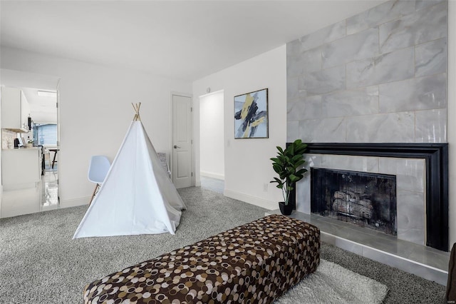 carpeted bedroom featuring a tile fireplace