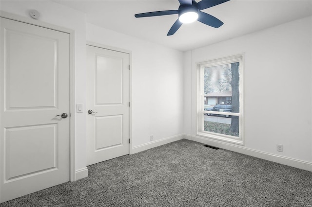 unfurnished bedroom featuring ceiling fan and carpet floors