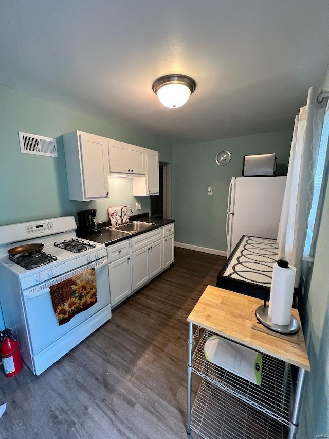 kitchen featuring white cabinets, dark hardwood / wood-style flooring, white appliances, and sink