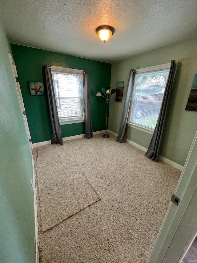 unfurnished bedroom featuring carpet and a textured ceiling