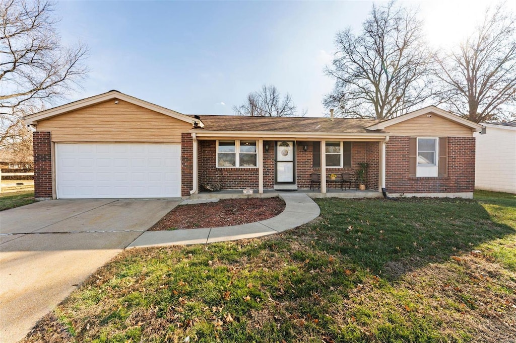 ranch-style home featuring a garage and a front lawn