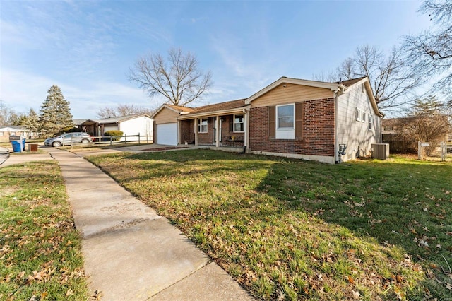 view of front of house with cooling unit, a garage, and a front lawn