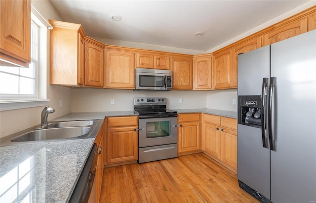 kitchen featuring sink, light hardwood / wood-style flooring, and appliances with stainless steel finishes