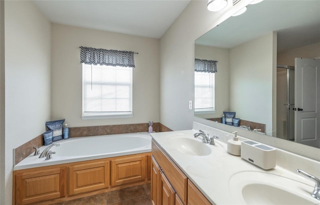 bathroom featuring tile patterned floors, vanity, and shower with separate bathtub