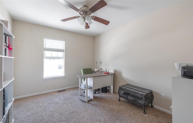 office space featuring plenty of natural light, ceiling fan, and light colored carpet