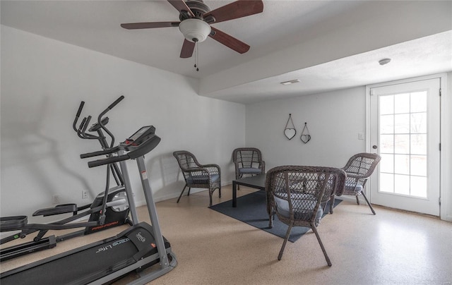 exercise room with ceiling fan and a healthy amount of sunlight