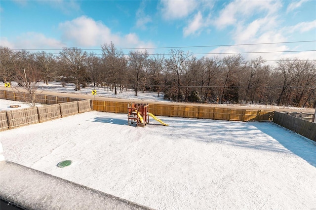 snowy yard with a playground