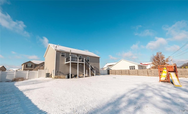 view of snow covered rear of property