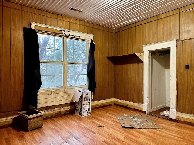 interior space with wood walls and wood-type flooring