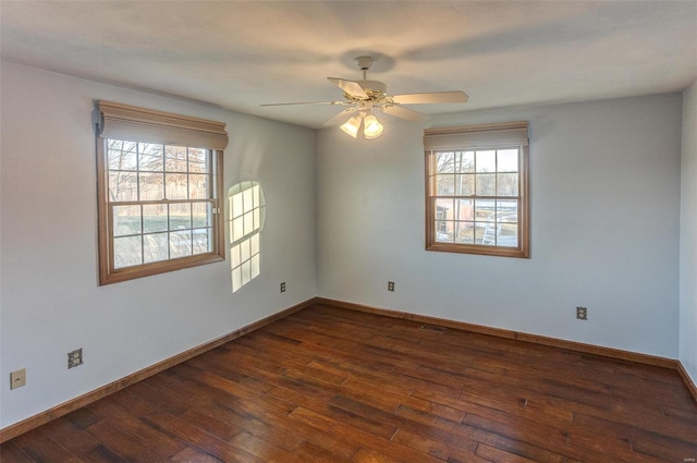 spare room with ceiling fan and dark hardwood / wood-style flooring