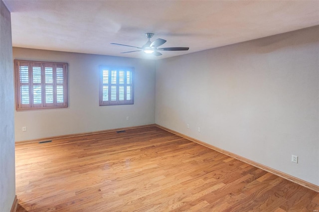 empty room featuring light hardwood / wood-style flooring and ceiling fan