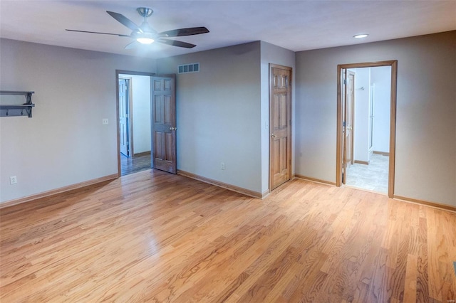 unfurnished room with ceiling fan and light wood-type flooring