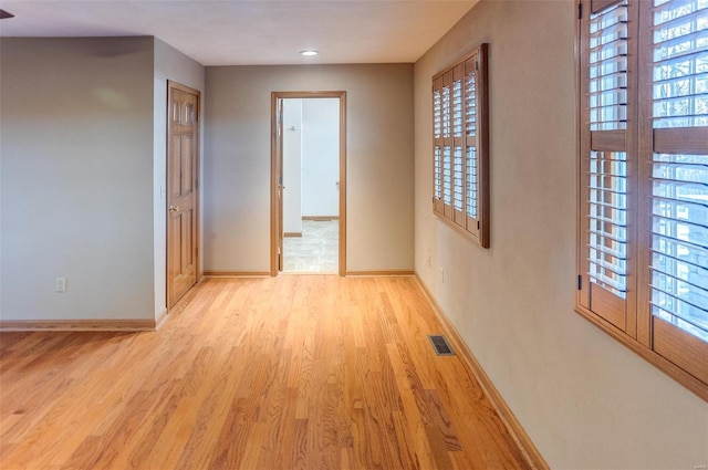 hallway with light hardwood / wood-style floors