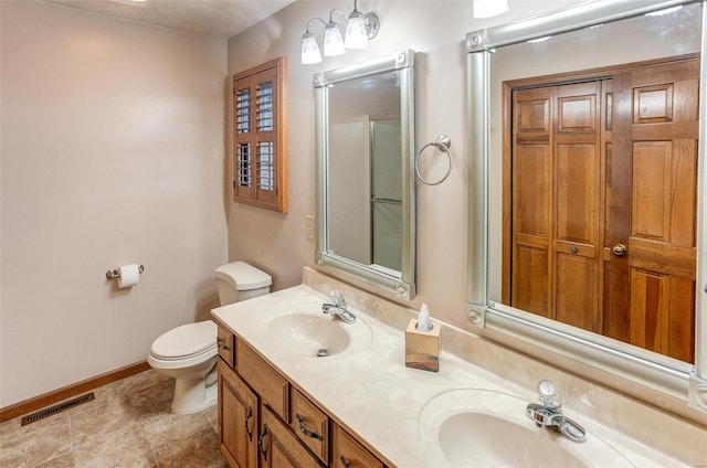 bathroom featuring walk in shower, vanity, and toilet