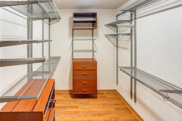 spacious closet with light hardwood / wood-style flooring