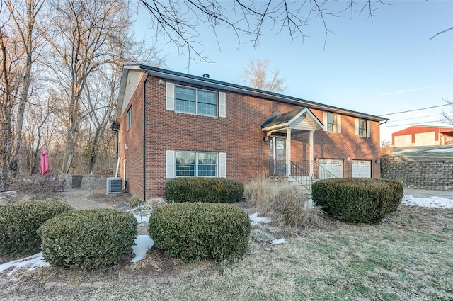 view of front of home featuring cooling unit and a garage