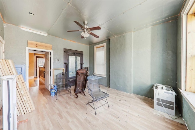 miscellaneous room featuring ceiling fan, light hardwood / wood-style flooring, and heating unit