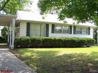 ranch-style house with a carport and a front lawn