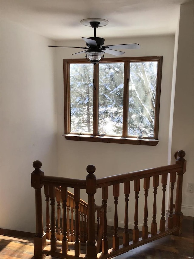 stairway featuring ceiling fan and a healthy amount of sunlight