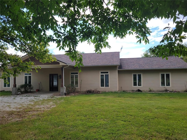 rear view of house with a yard