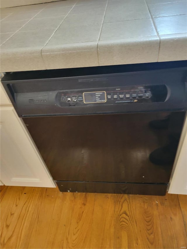 interior details featuring dishwashing machine and wood-type flooring