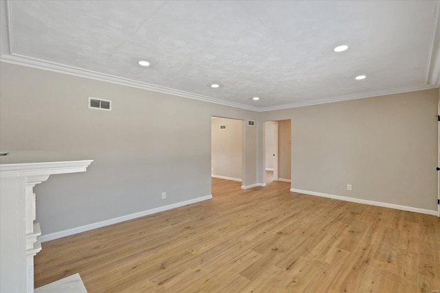 spare room featuring crown molding and light hardwood / wood-style flooring