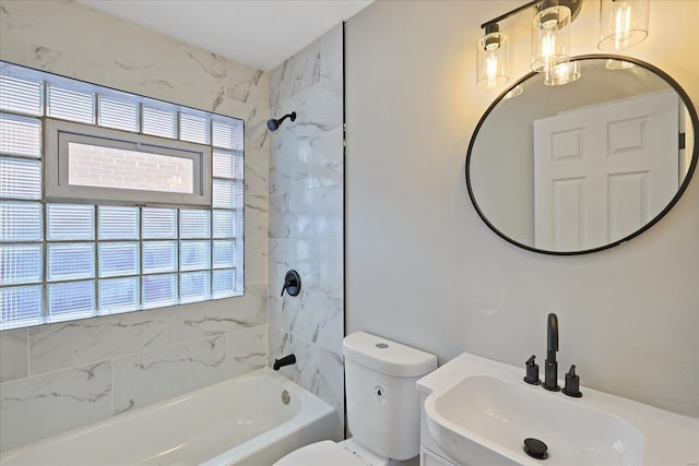 full bathroom featuring toilet, tiled shower / bath combo, and sink