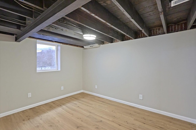 basement with hardwood / wood-style floors