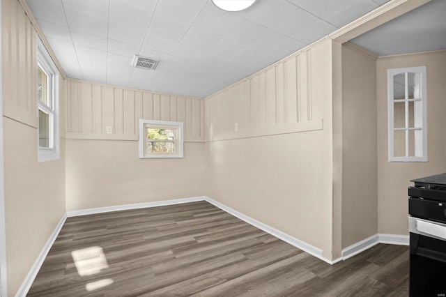 spare room with hardwood / wood-style flooring and a healthy amount of sunlight