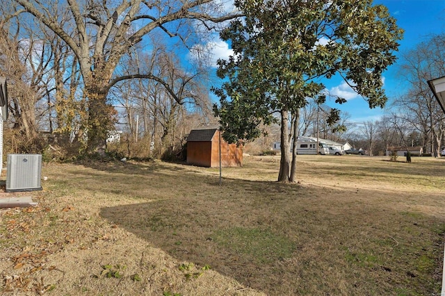 view of yard with central AC unit and a storage unit