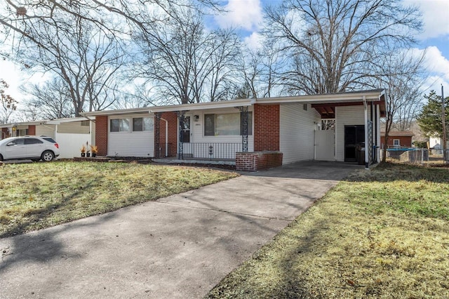 ranch-style house featuring a carport and a front lawn