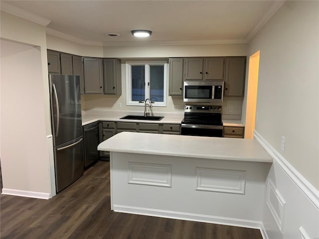 kitchen with gray cabinetry, ornamental molding, sink, and appliances with stainless steel finishes