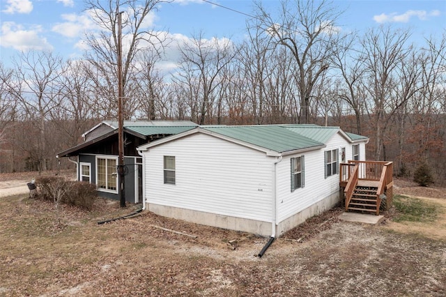 view of property exterior featuring a wooden deck