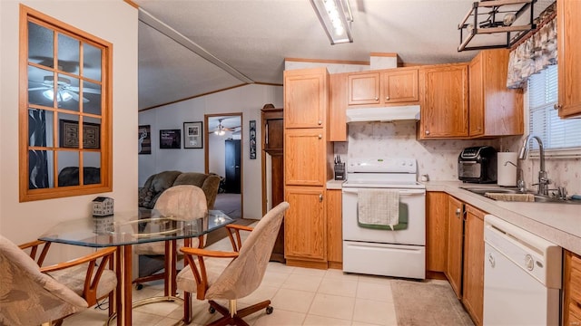 kitchen with light tile patterned flooring, lofted ceiling, sink, white appliances, and decorative backsplash