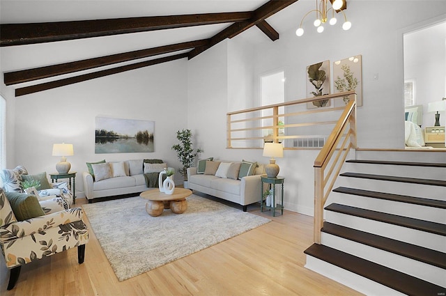 living room with hardwood / wood-style floors, lofted ceiling with beams, and a chandelier