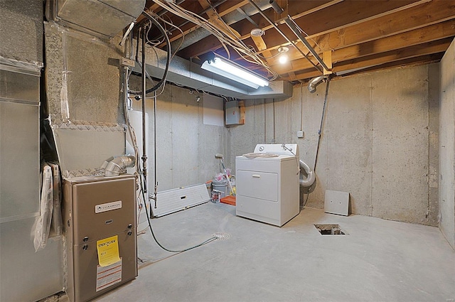 basement with electric panel, washer / dryer, and heating unit