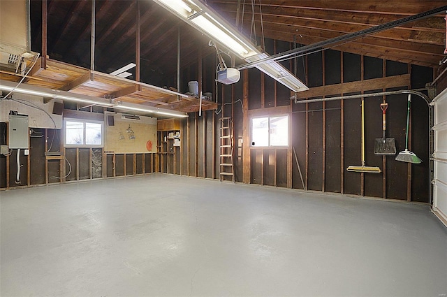 garage with a garage door opener and electric panel