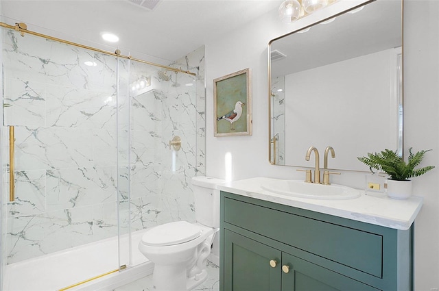 bathroom featuring toilet, vanity, and a shower with shower door